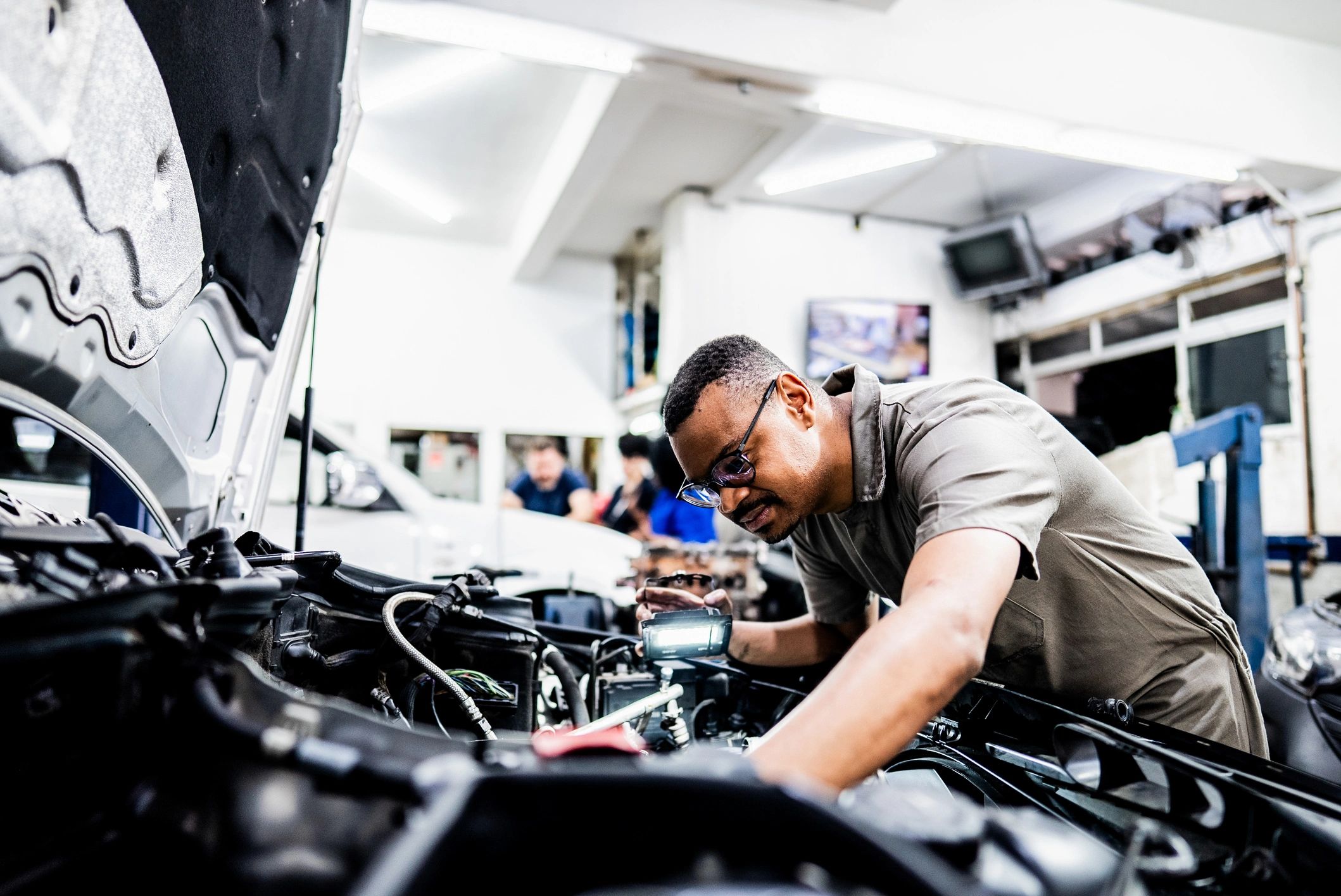 ASE-certified technician servicing a Japanese vehicle in a modern repair bay